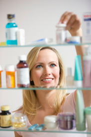 Woman looking at pill bottles