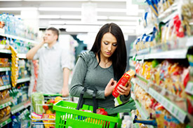 Woman with shopping cart in a grocery store