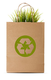 Paper bag with recycle symbol and green grass