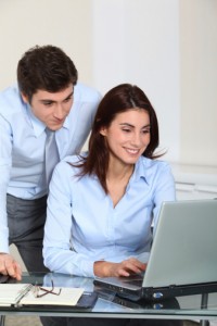 Office workers in front of laptop computer