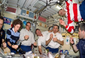 STS-110 crew eating at the International Space Station.