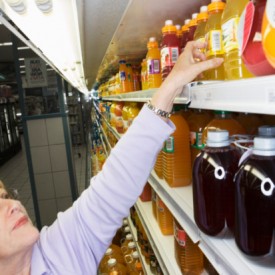 Woman Selecting Juice Bottle