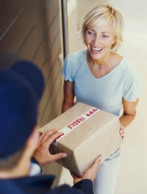 Woman receiving a package from a delivery man